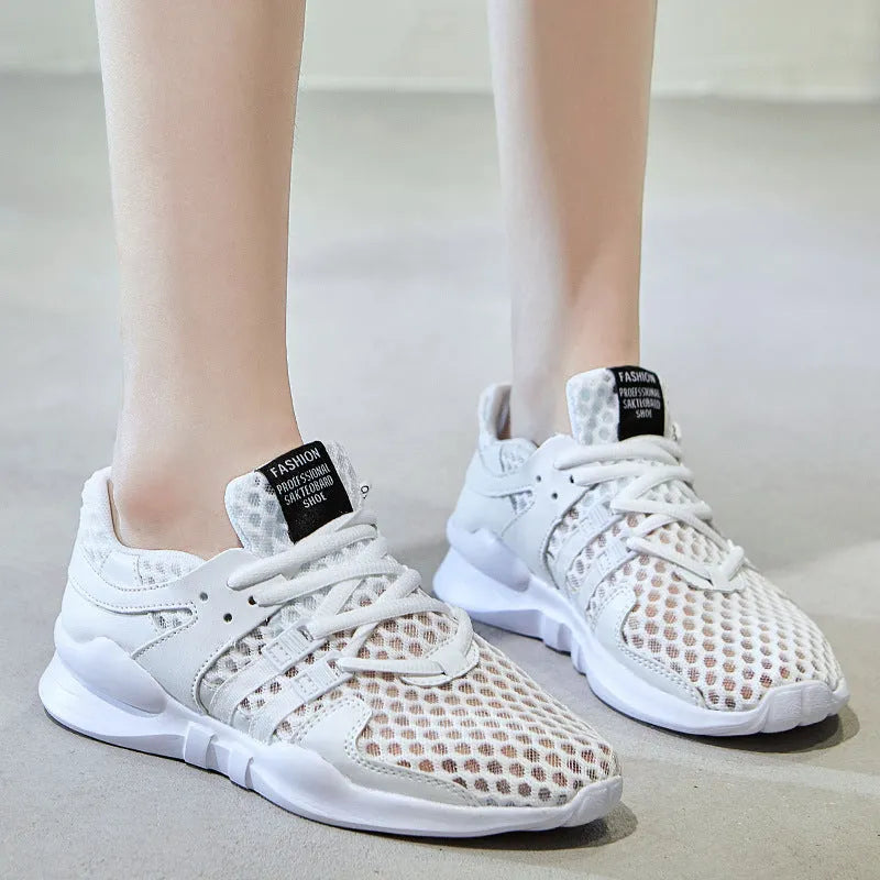 Women's low-top hollow mesh sneakers in white on a solid background.