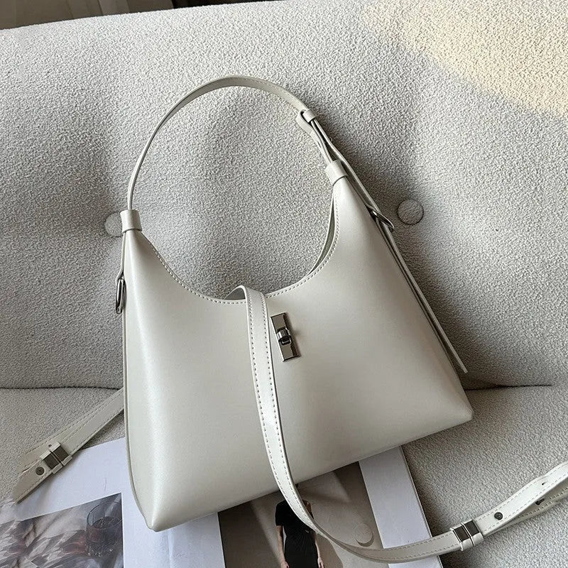 Soft genuine leather dumpling-shaped crossbody shoulder bag in a street style with lock detail