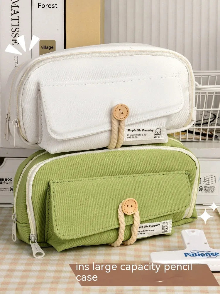 Korean-style canvas pencil case in green, beige, blue or grey holding multiple pens