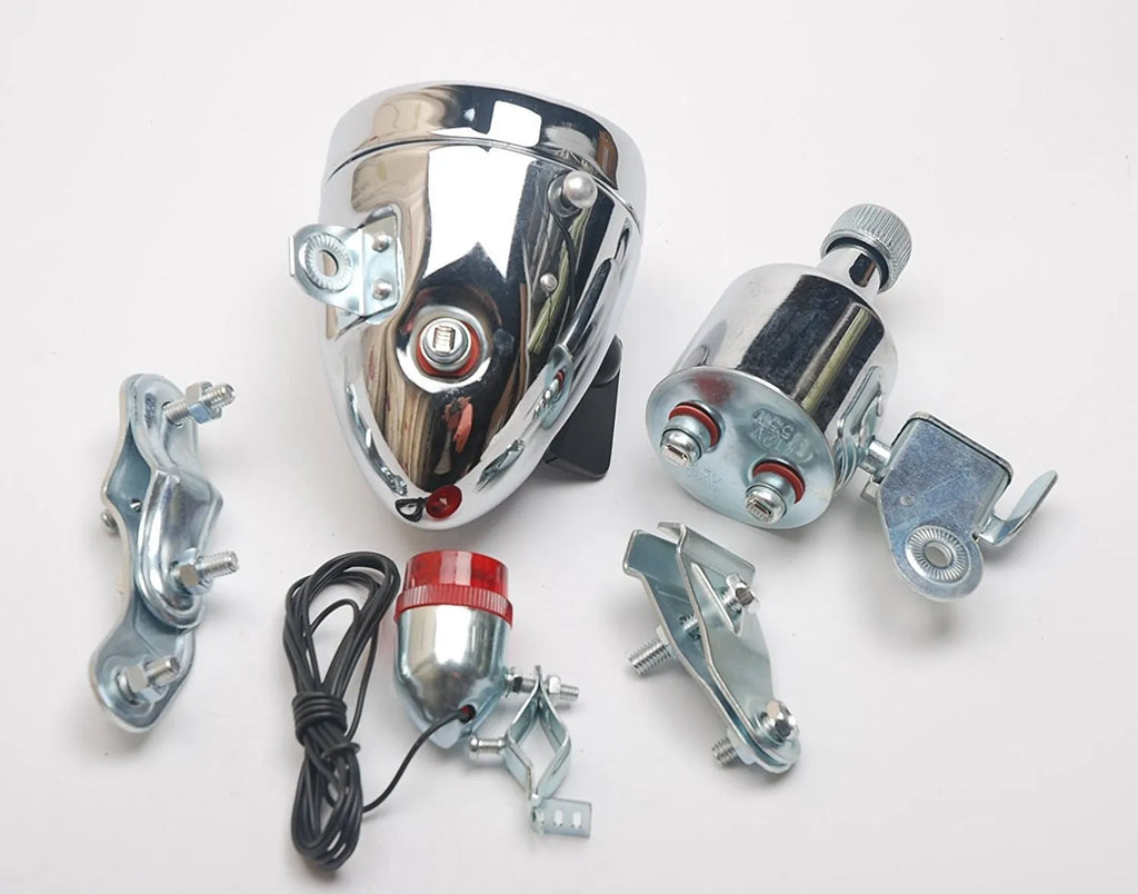 Silver bicycle dynamo generator light kit mounted on a bike fork, with wires for headlight and tail light connections.