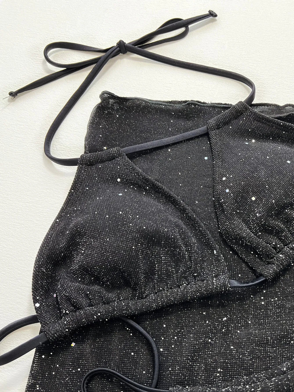 Black three-piece bikini swimsuit set with polyester fabric top and matching shorts