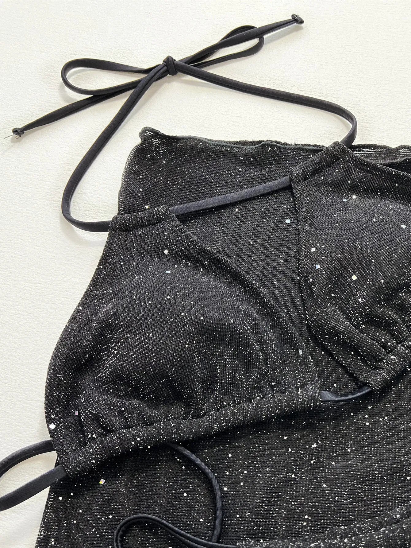 Black three-piece bikini swimsuit set with polyester fabric top and matching shorts