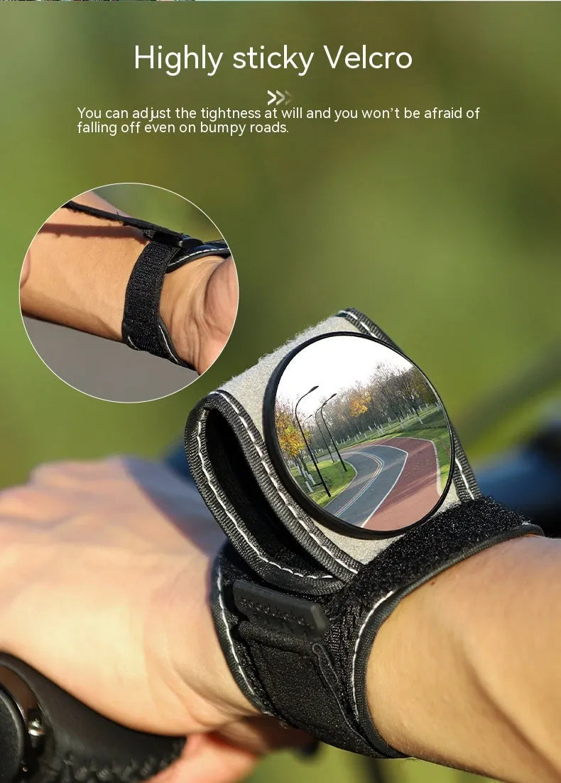 Black nylon wrist-mounted bicycle rear-view mirror with adjustable angle and secure strap for handlebar installation