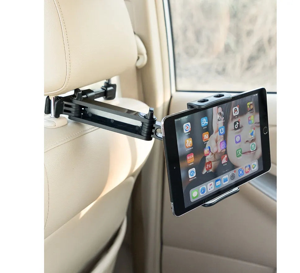 Black plastic car phone holder attached to a vehicle rear seat base holding a tablet