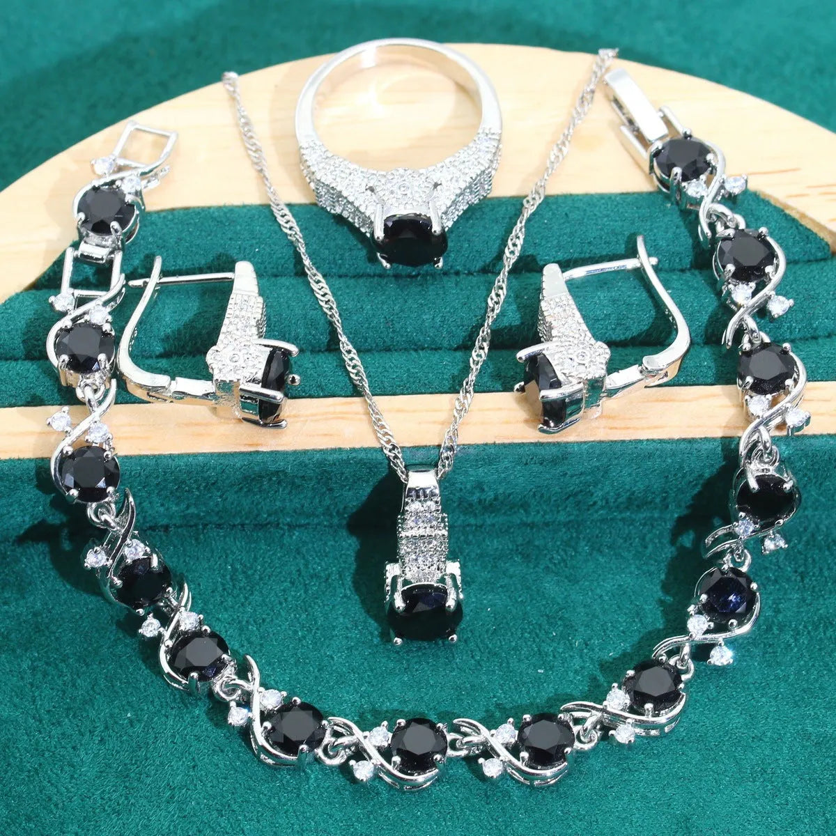 Bridal zircon jewellery four-piece set showing necklace, bracelet, earrings, and ring with water wave chain styling