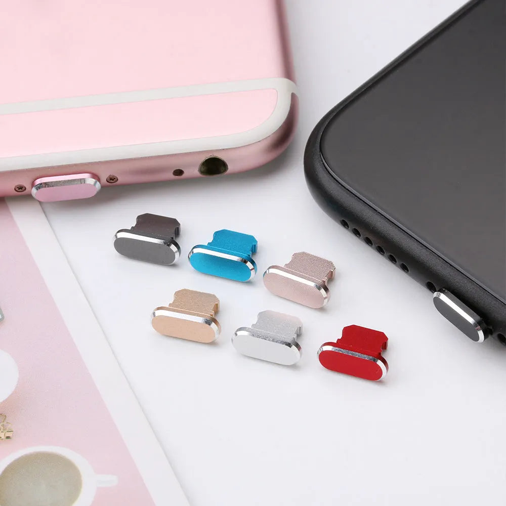 Aluminium alloy iPhone charging port dust plug in multiple colours including gold, silver, blue, red, grey, black, and rose gold.