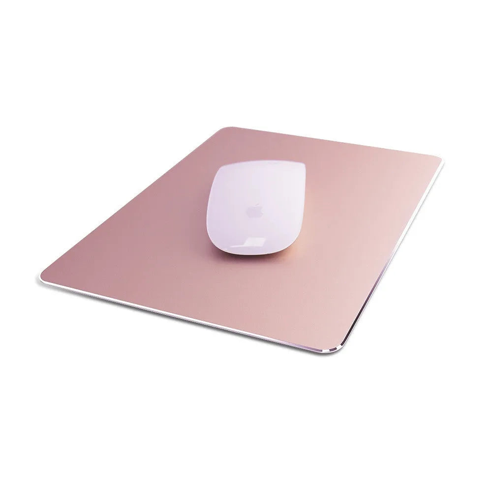 Double-sided aluminium non-slip mouse pad in black on a desk with a mouse and keyboard