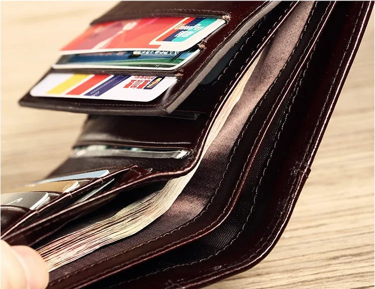 Men's leather wallet open showing photo slot, card holders, banknote section and change compartment
