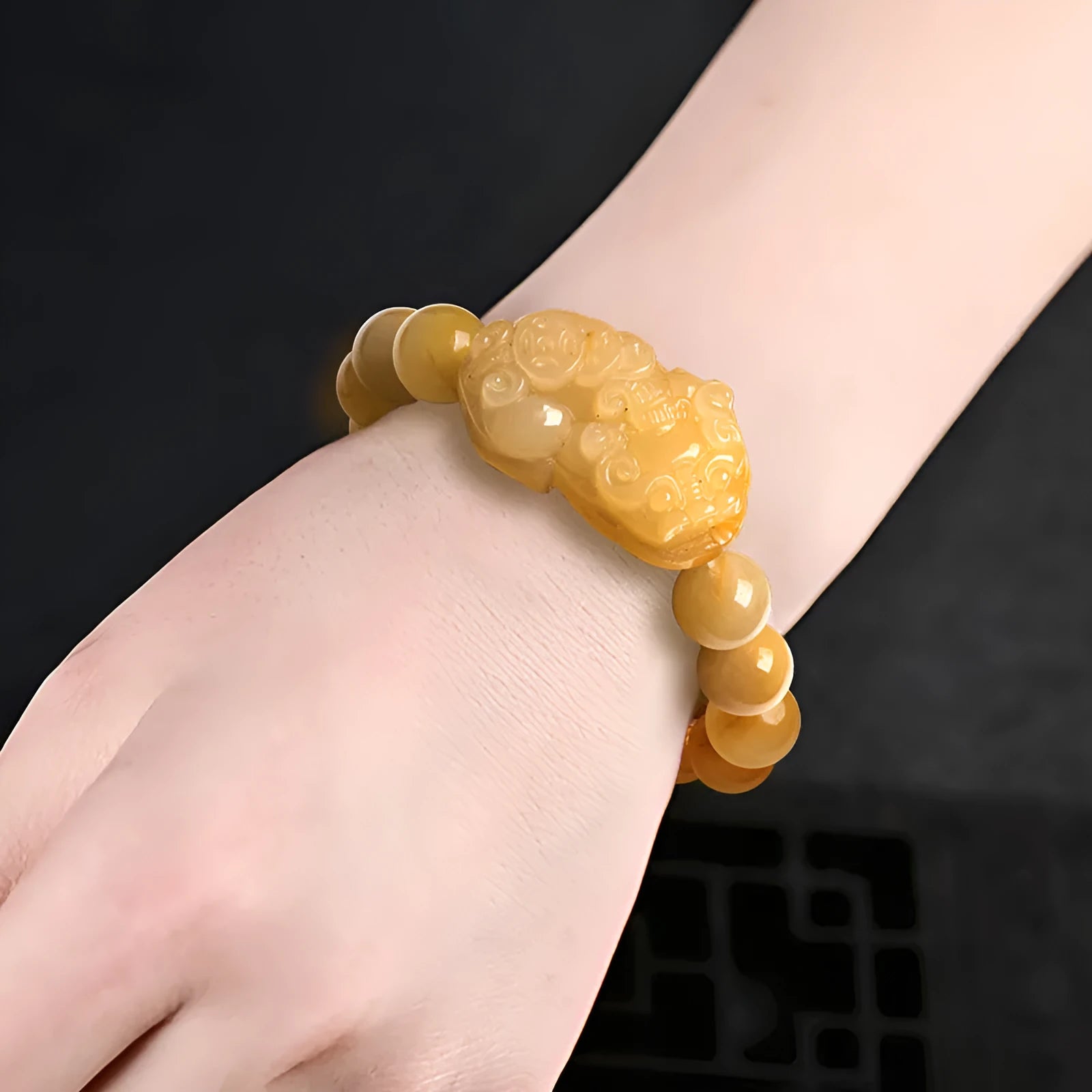 Hand-carved Golden Thread Jade money bracelet with coin design, shown in two bead size options.