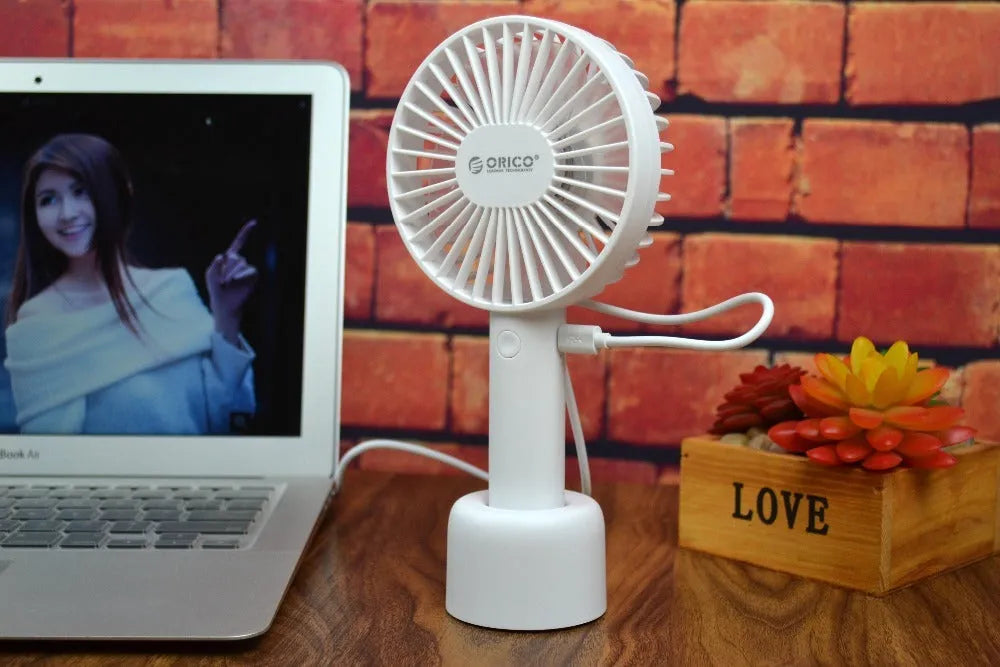 White ORICO FH1 portable USB rechargeable desk fan with fine-line texture on a desktop