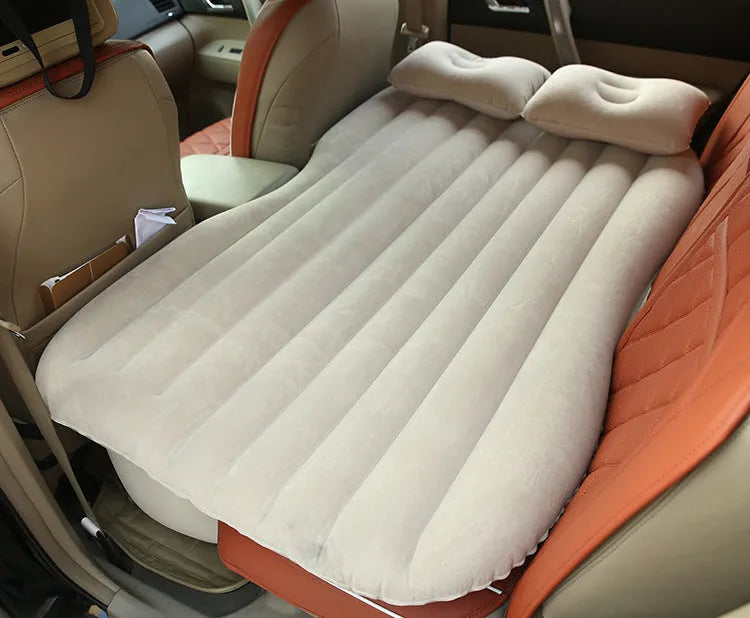Universal inflatable car bed with flocking material, shown with pump, pillows, and storage bag.