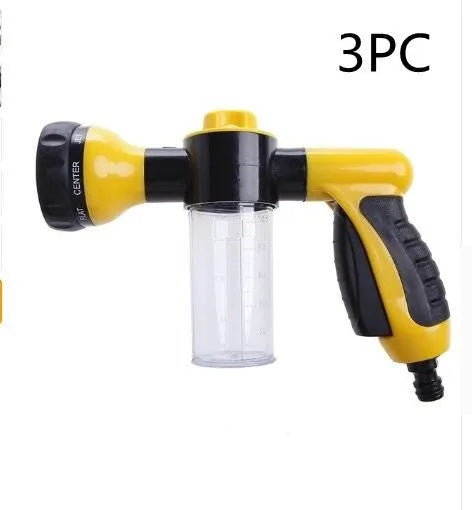 Green high-pressure foam spray gun with adjustable nozzle and attached water hose for car and garden cleaning.