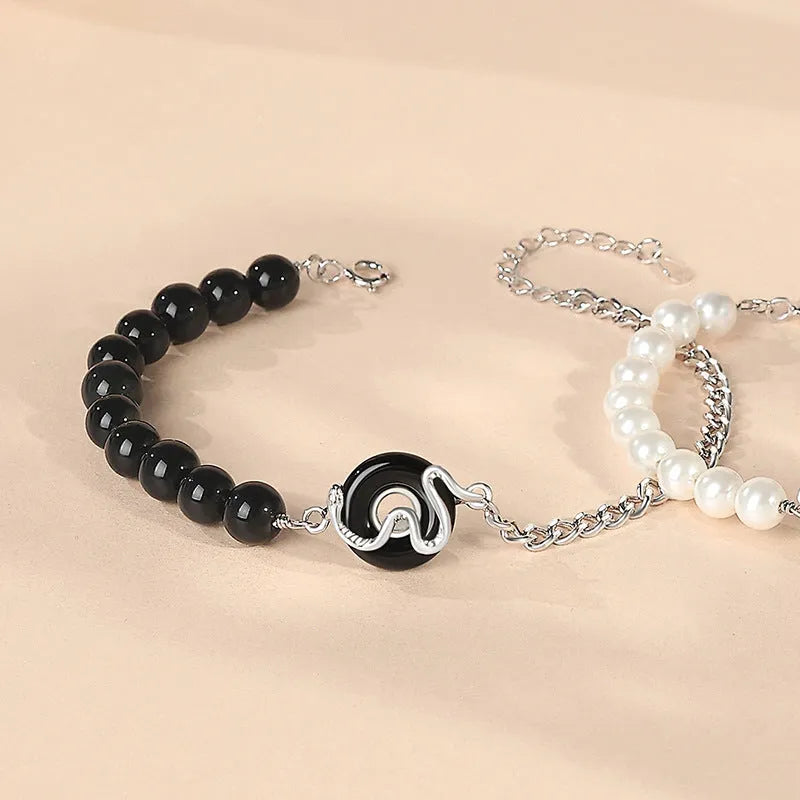 925 sterling silver couple bracelet with safe buckle, snake zodiac design, and obsidian pearl details in New Chinese style.