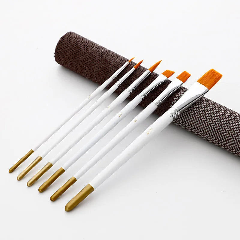 Set of six paint brushes with wooden handles and silver ferrules on a white background