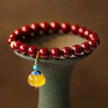 Close-up of a handcrafted wave-shaped cinnabar and copper bead bracelet in national style.