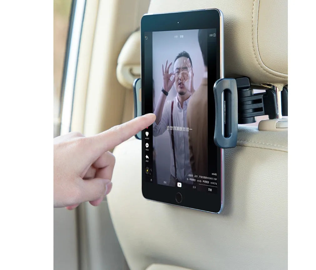 Black plastic car phone holder attached to a vehicle rear seat base holding a tablet
