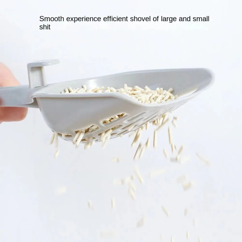 Grey plastic cat litter scoop with perforations and a separate storage base for cat litter box cleaning.