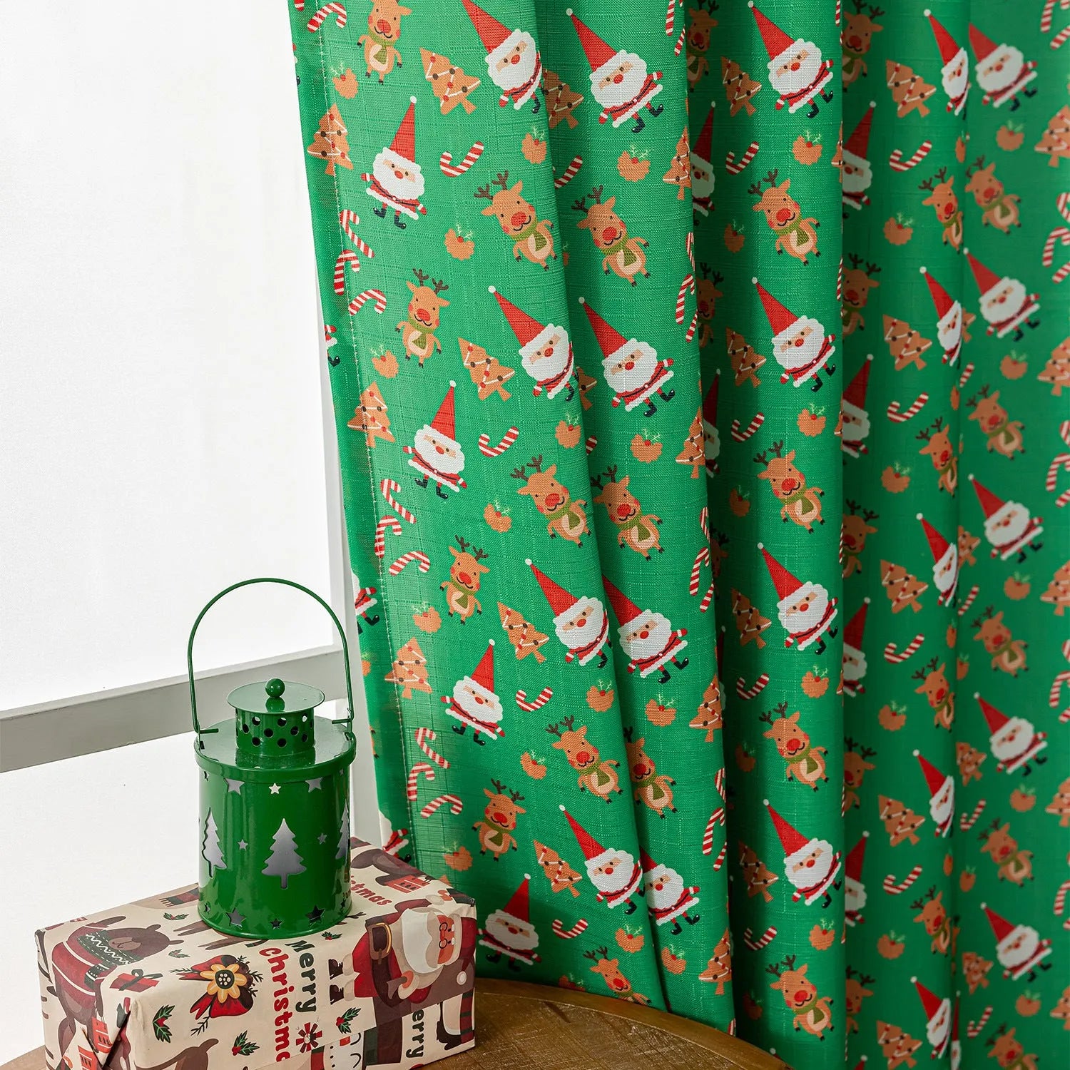 Green Christmas curtain with printed snowman and angel cartoon figures pattern