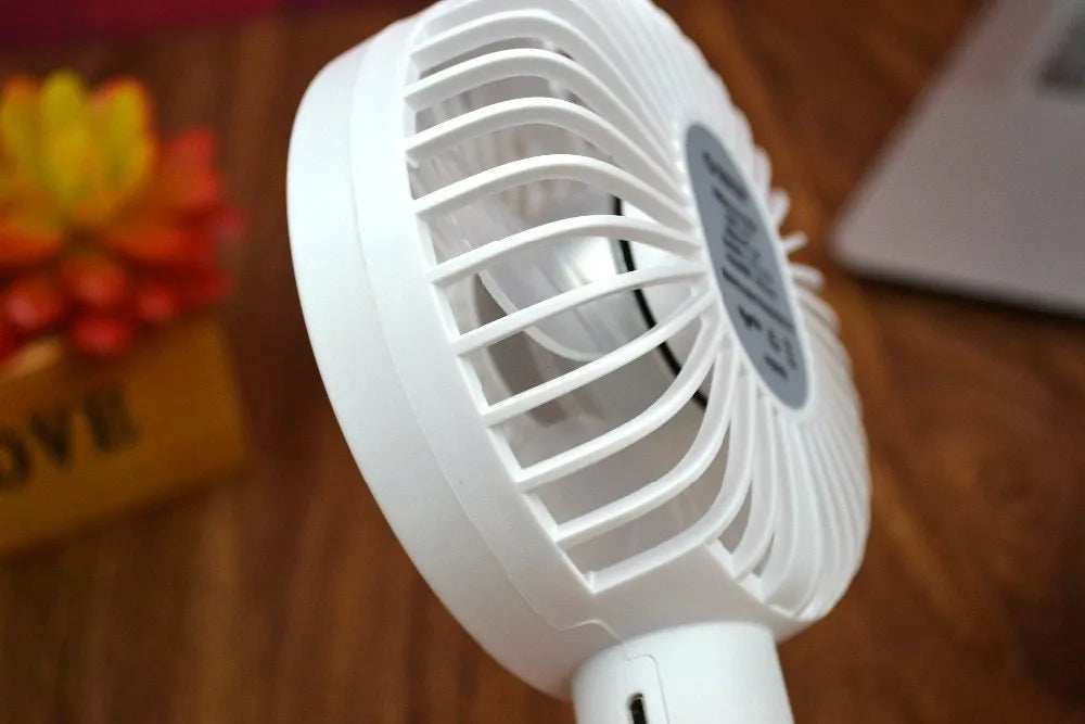 White ORICO FH1 portable USB rechargeable desk fan with fine-line texture on a desktop