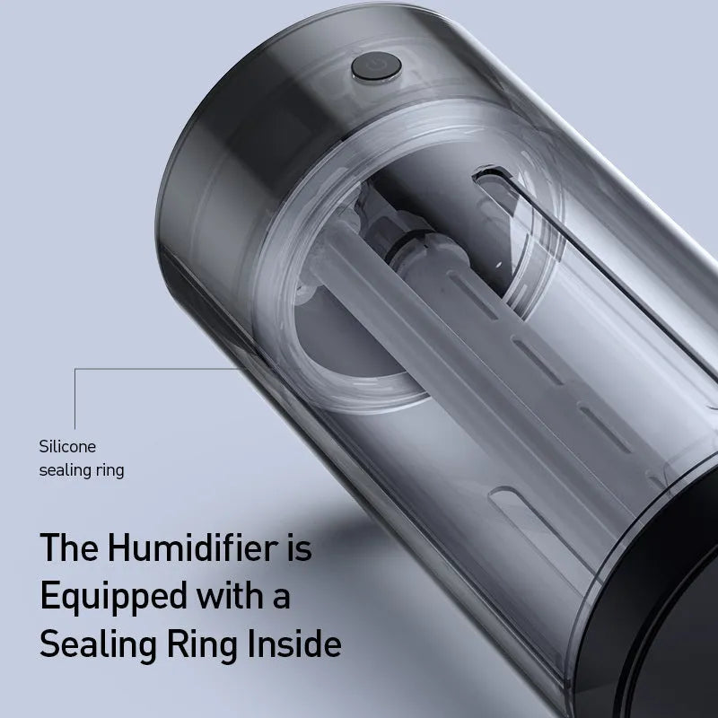 Black aluminium alloy car diffuser humidifier with USB cable on a desk.