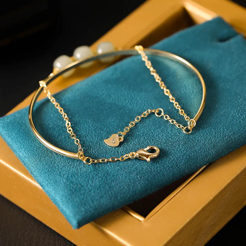 Women's jade lucky beads bracelet with gold inlay in single, double, and three bead versions.