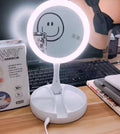 White foldable LED vanity mirror showing 1x and 5x magnification sides and USB charging port.
