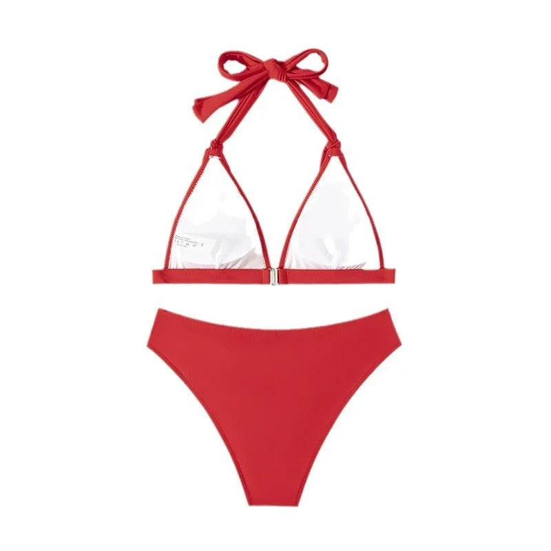 Red women's lace-up halterneck bikini set with separate shorts on a white background