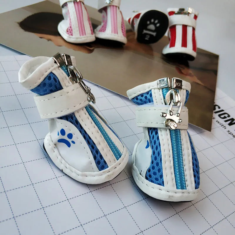 Set of four blue cloth dog shoes with zip closure and non-slip soles for pets.