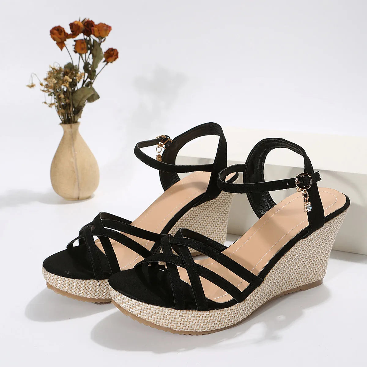 Women's black wedge sandals with fabric upper and fish mouth toe opening.