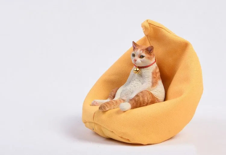 Small resin cat ornament sitting on fabric sofa for car dashboard decoration