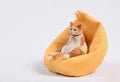 Small resin cat ornament sitting on fabric sofa for car dashboard decoration