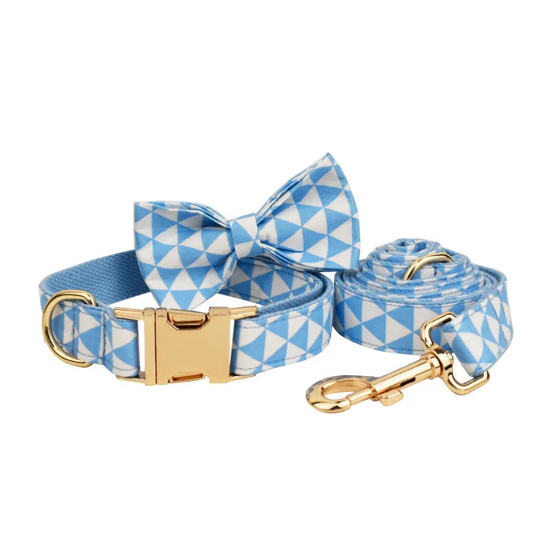 Blue four-piece dog clothing set showing vest, collar, lead and bow accessory in adjustable sizes from XS to XL