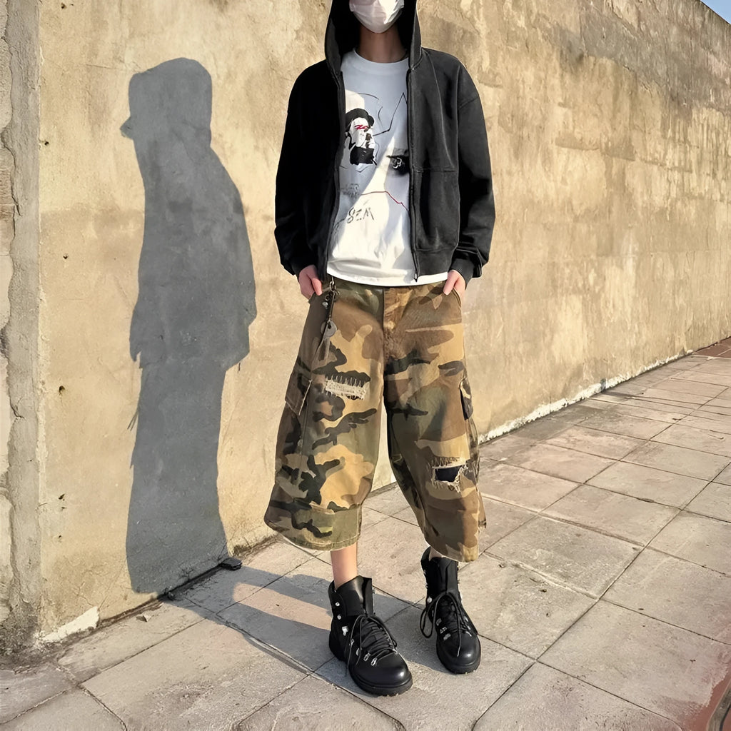 Men's loose-fit camouflage cropped jeans with ripped knee detailing, shown in a straight-leg silhouette.