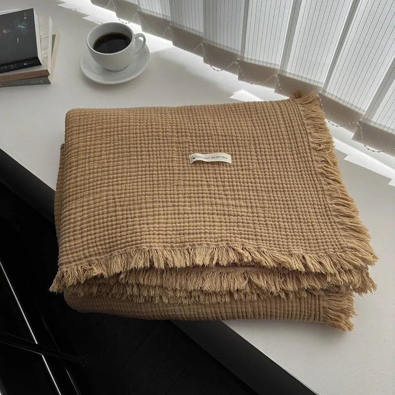 Four-layer gauze cotton blanket with tassel trim in a choice of ten colours and two sizes.