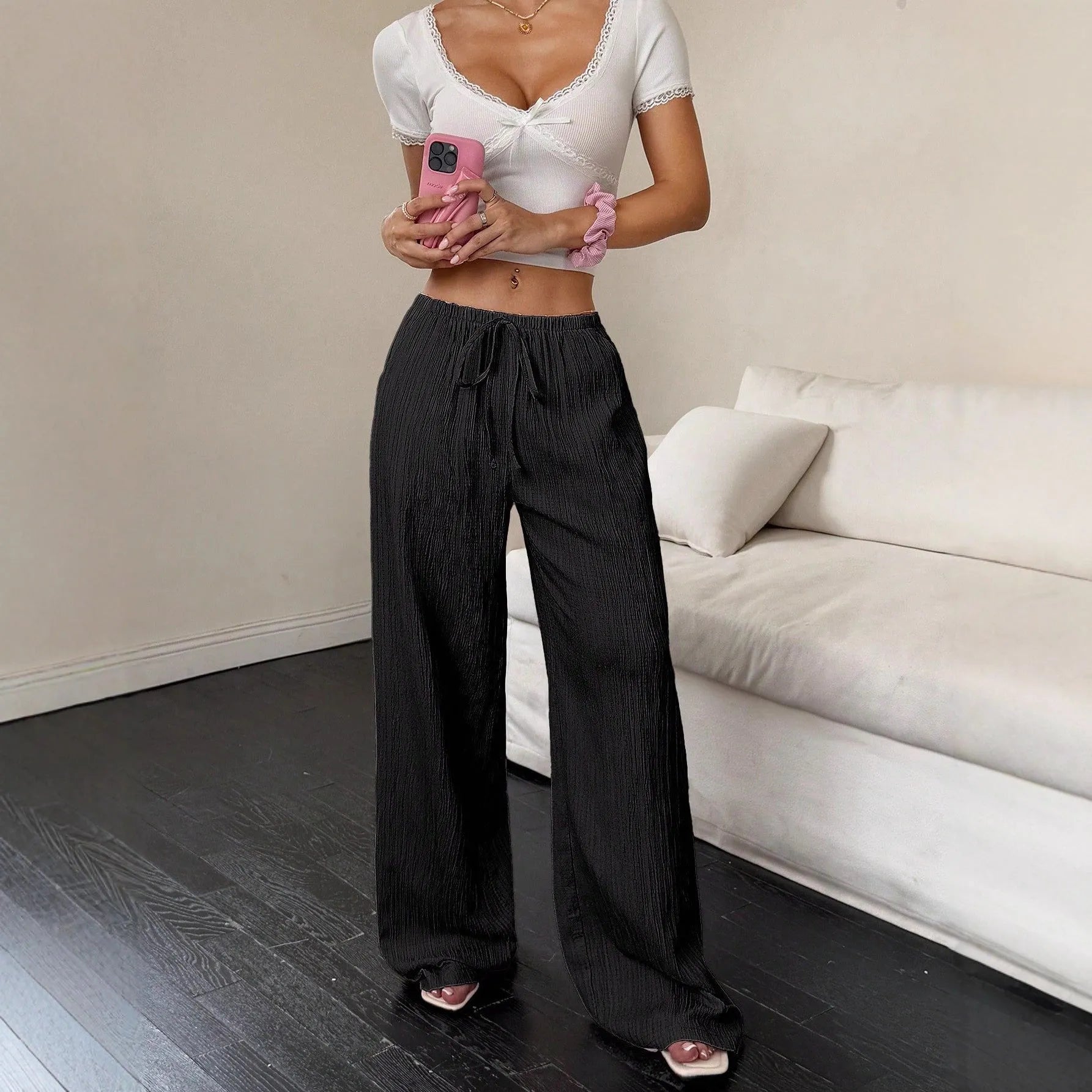 Women's black wide-leg trousers with lace-up waist detail front view