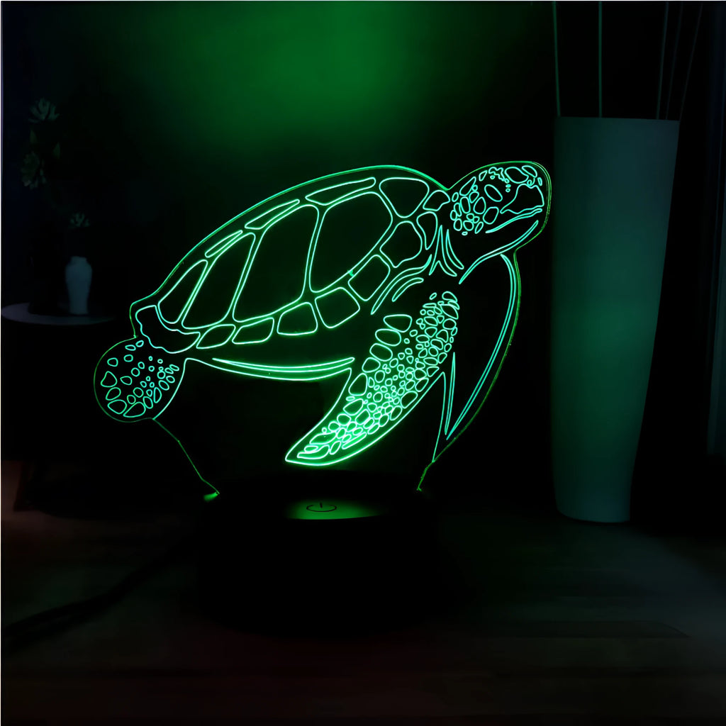 3D acrylic turtle-shaped LED night light with multi-colour glow on a surface.