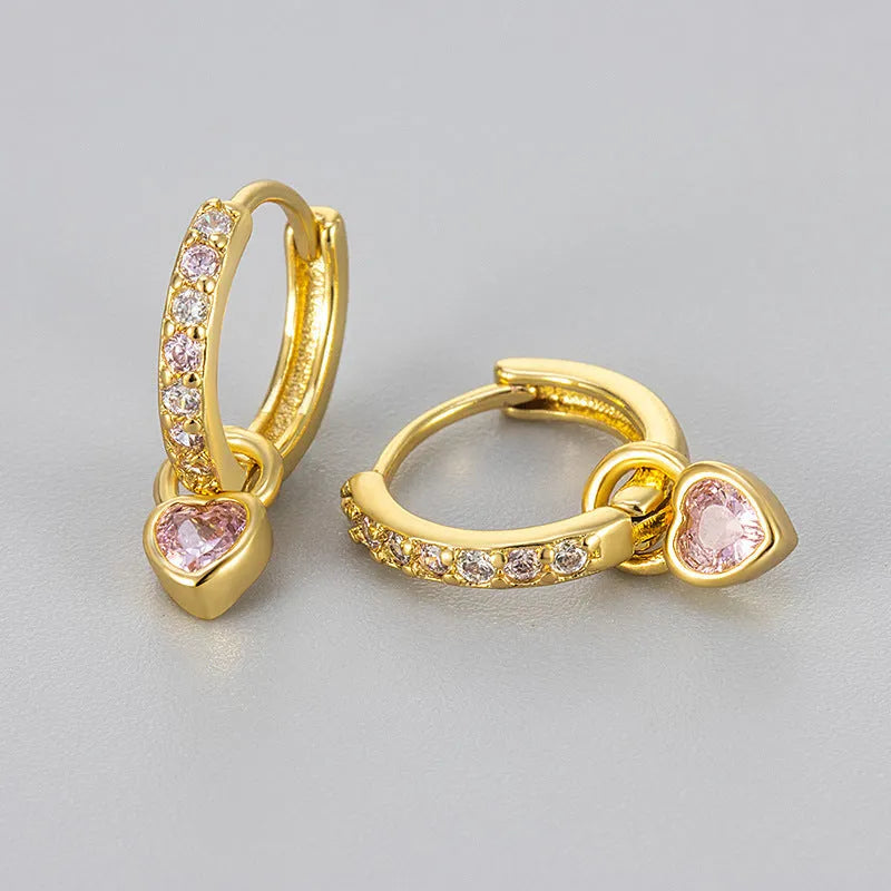 Women's gold tone earrings with a heart-shaped clip and a pink zircon drop pendant.