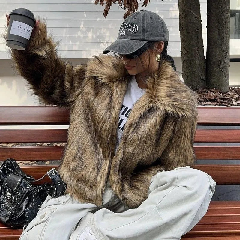 Women's short length artificial fur coat with a fur collar in a black tip on black background colour.
