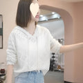 Women's blue crochet hollow hooded longsuit undershirt with long sleeves on a hanger