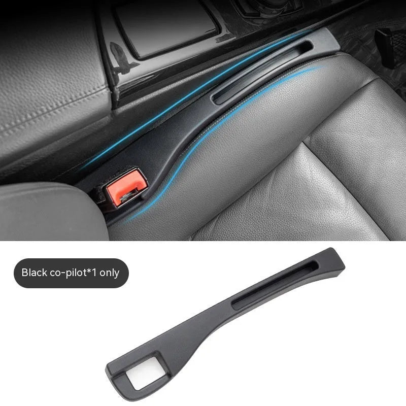 Black plastic car seat gap storage box with handle between vehicle seats