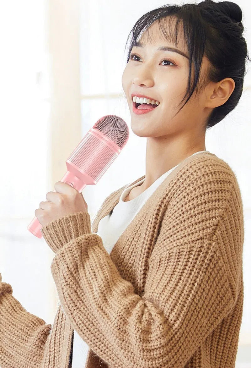 Wireless Bluetooth karaoke microphone in pink, blue, or green with integrated audio system