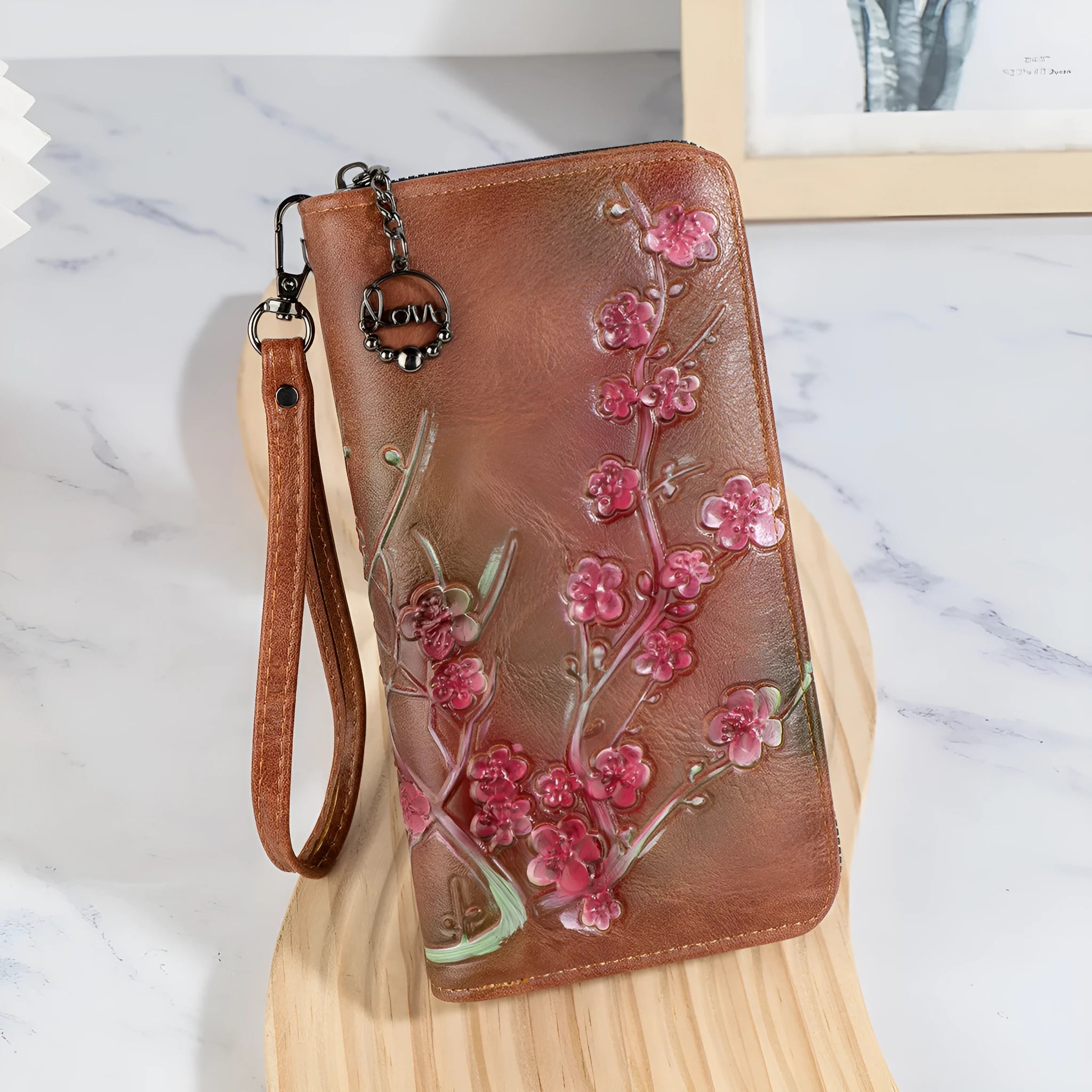 Embossed floral handbag with hand-painted details and a brass zipper in a retro style.