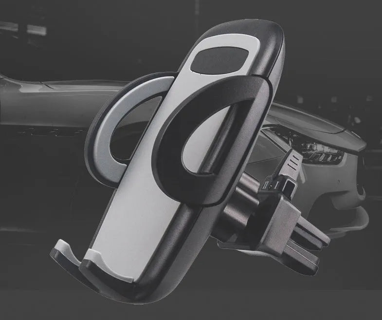 Black plastic mobile phone holder mounted on a car air conditioning vent