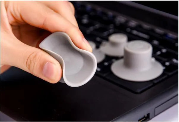 Set of four grey non-slip plastic cooling pads for laptops, shown in two different sizes.