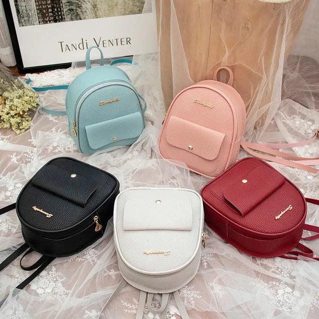 Small black PU women's shoulder backpack with zipper closure showing compact dimensions