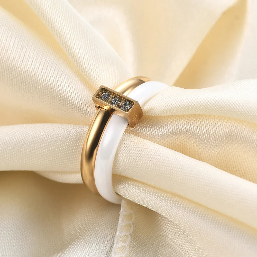 Women's glossy ceramic ring with geometric zirconium inlay in golden white or steel black colour