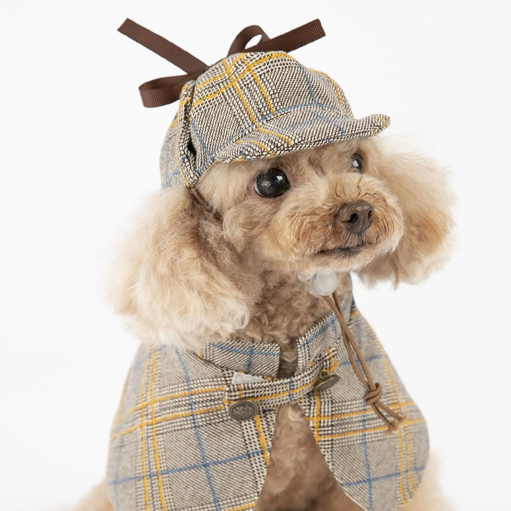 Camel coloured cotton detective cloak for dogs on a hanger, showing the adjustable hat.