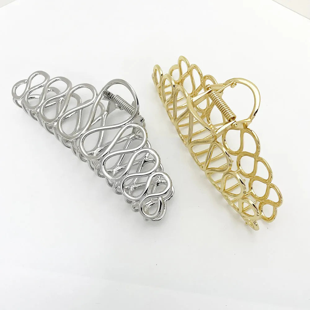 Minimalist large hair clip with tassel detailing in gold or silver metallic finish for updo hairstyles