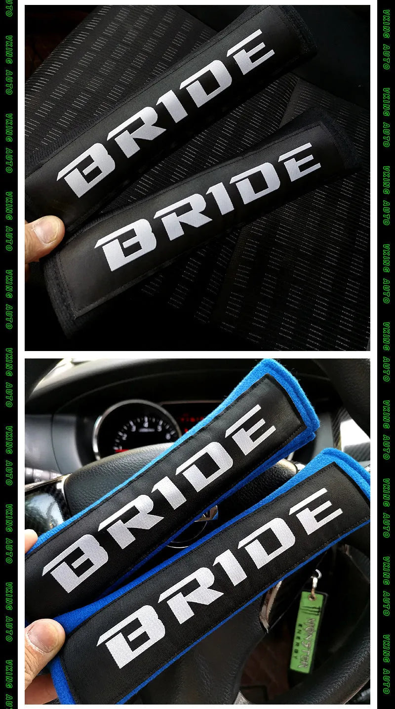Pair of black car seatbelt shoulder pads showing embroidery detail and thickness