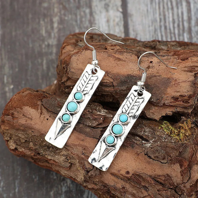 Silver geometric earrings with a long strip design and a blue turquoise inlay